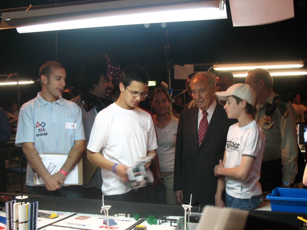 Golanix students presenting a robot at a robotics competition